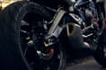 Features twin discs with Brembo M4.32 calipers Triumph Street Triple R in orange rear tyre shot